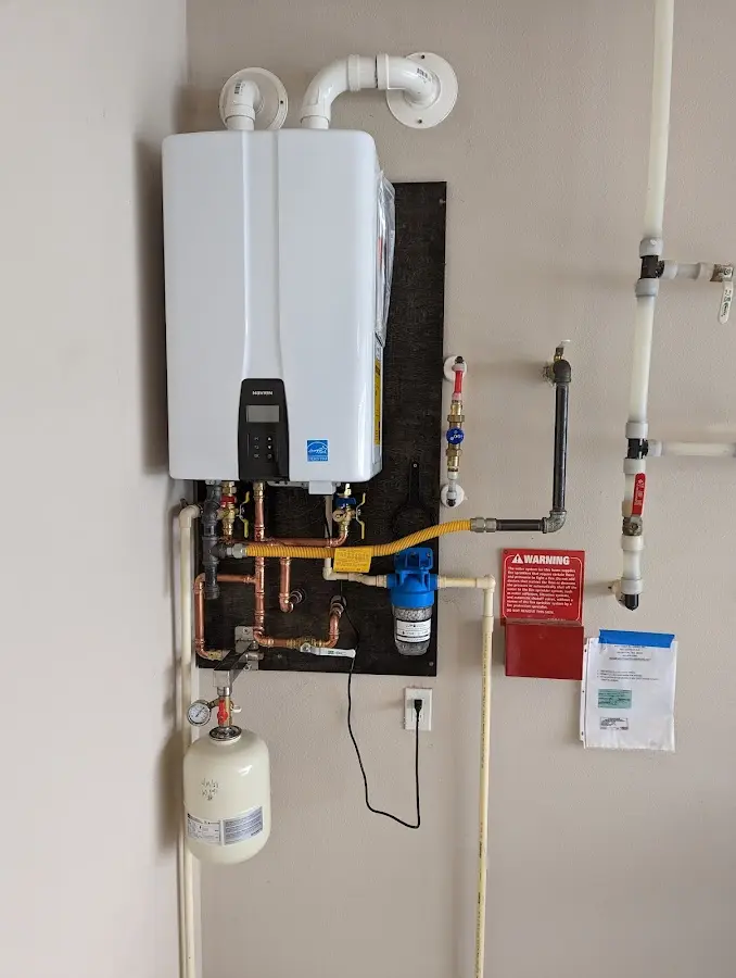 Professional plumber installing copper piping in a Jupiter Farms home